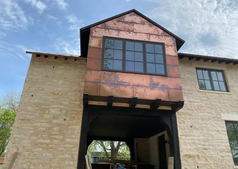 Copper metal panel facade on a stone building for Metal Roof Coating in Calhoun