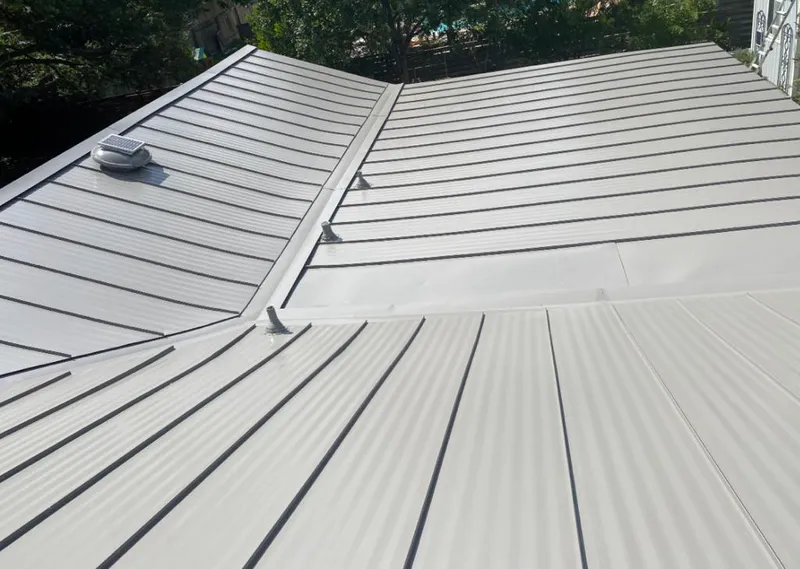 Solar attic fan installed on a metal roof for Roof Ventilation in Calhoun